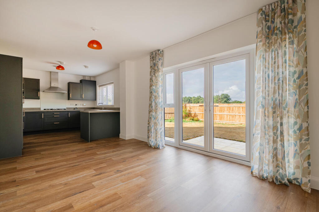 Actual photograph of the kitchen, dining and family room